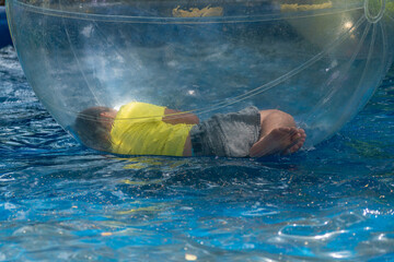 Attraction balloon on the water with a child inside.