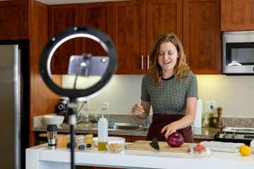 Woman Prepares a Meal While Recording on Her Phone
