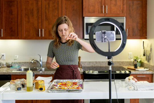 Woman Cooks in front of Phone Recording