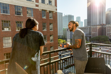 Man and Woman Look at Each Other on Urban Balcony