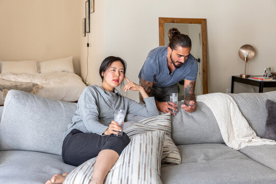 Man and Woman Browses TV on Couch