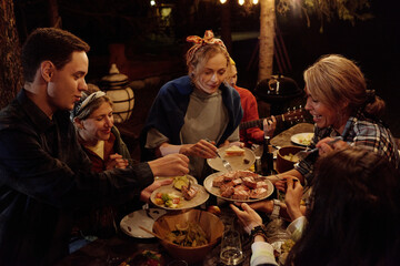 Friends Having Barbecue At Night