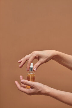 Crop woman demonstrating essential oil