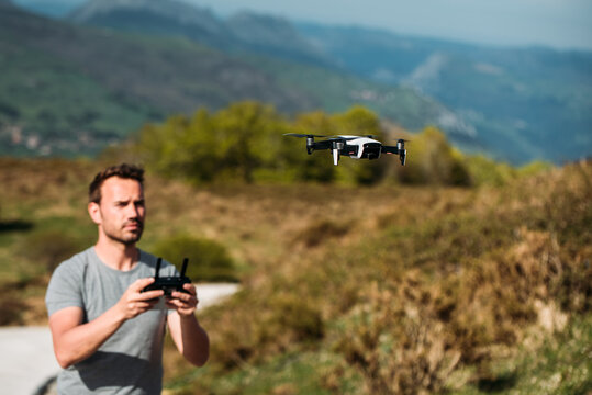 Man controlling flight of drone in highlands