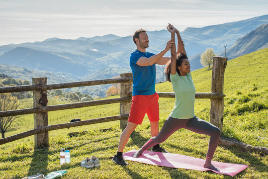Multiracial couple training together in mountains