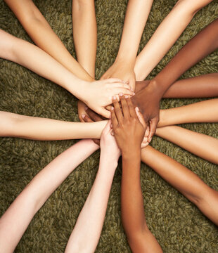 Group of diverse women's hands connected together 