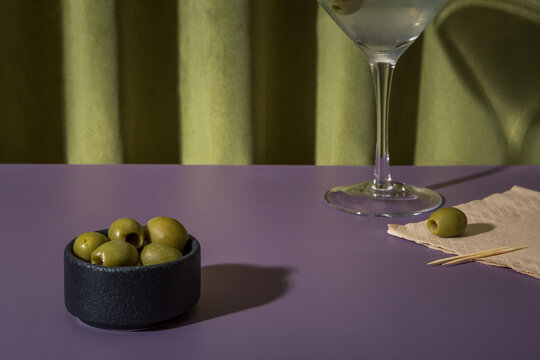 Green olives and a cocktail - Powered by Adobe