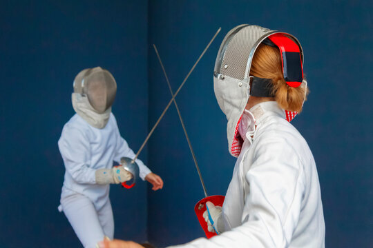 Anonymous women having fencing training together