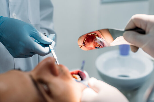 Dentist examining patient's teeth