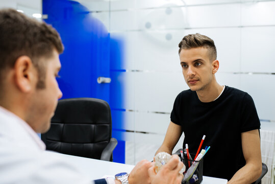 Male dentist with patient in the office
