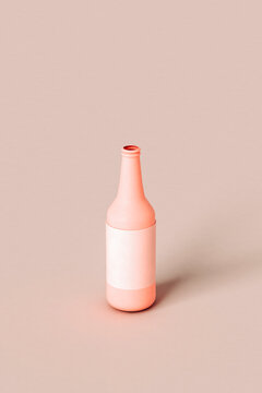 Pink beer bottle on pink background