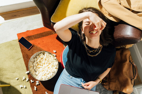 Greedy Woman with Popcorn and Laptop