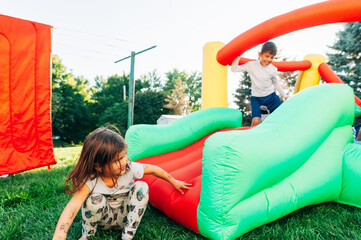 Happy children playing on bouncy house.