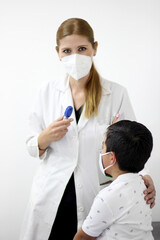 Female professional pediatrician doctor working checking a happy latin child

