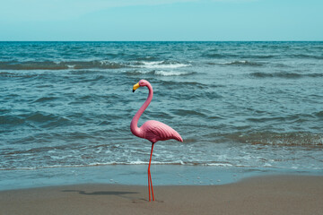 fake pink flamingo on the seashore