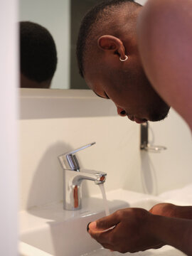 Man washing face in the morning.