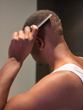 Man combing his hair.