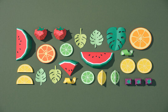 Fruit made of paper. Green background.