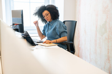 Woman With Afro Hair Working At Office