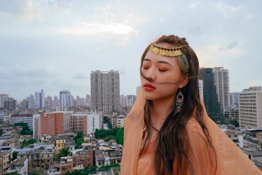 Fashionable Asian woman in veil skirt portrait