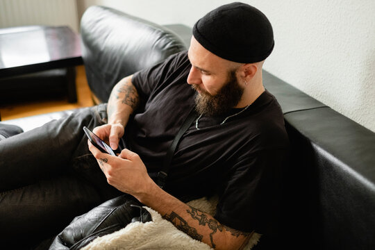 Tattooed Smiling Berliner Guy Laid On The Couch 