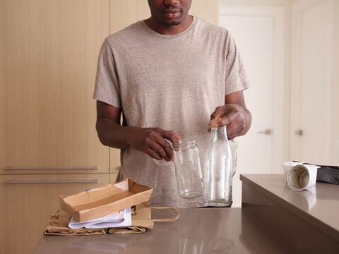 Man with glass for recycling.