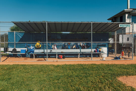 Dugout filled with baseball gear. 