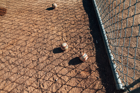 Baseball laying in the dirt. 