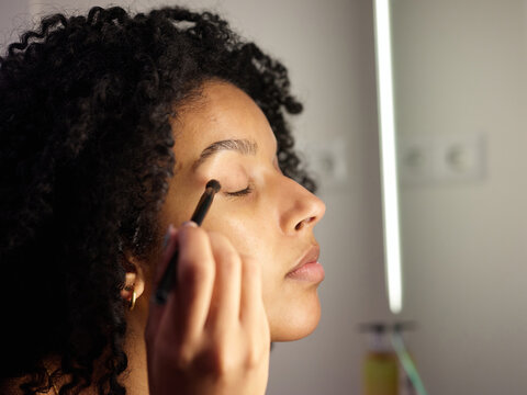 Woman doing make-up.