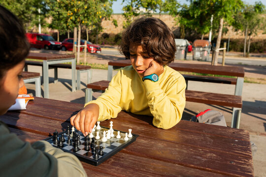 Kids playing chess outdoor