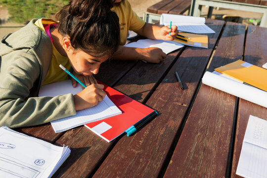 Kids doing homework outdoors