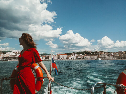 Woman in red dress in a middle of a sea
