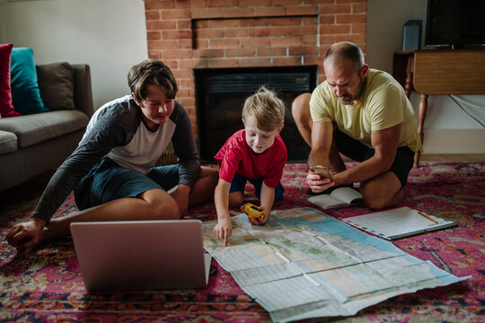 Brothers and dad looking at map