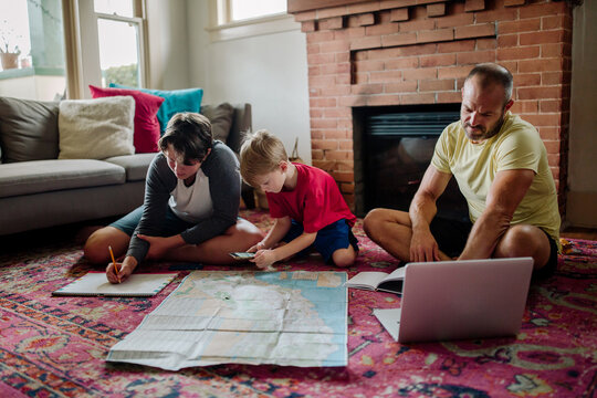 Brothers study map with help from dad