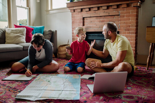 Dad talking with sons while planning trip