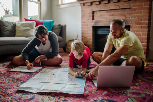 Dad helping sons with map