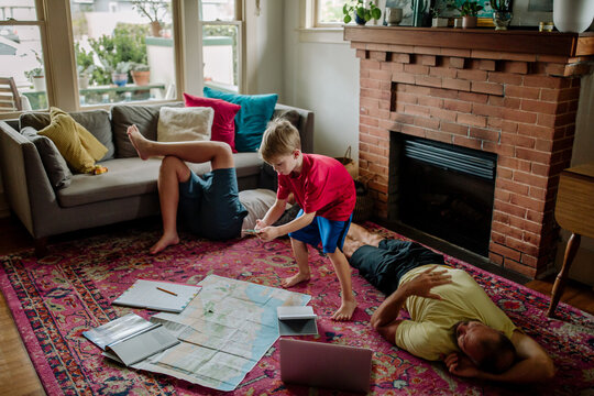Young boy plans trip with map