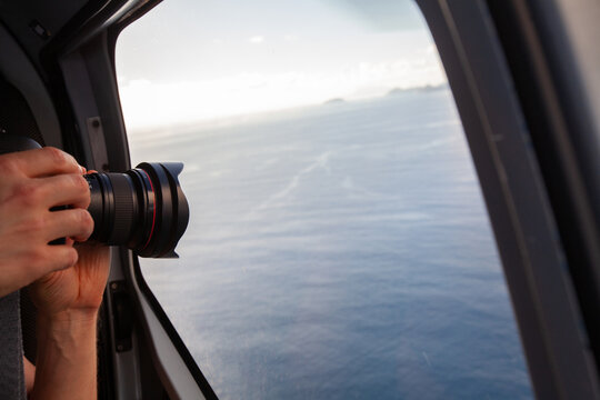 photographer taking photo from helicopter window