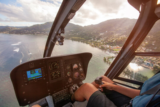 dashboard of helicopter and hands of pilot