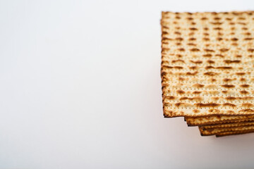 Traditional Jewish bread-matzah. Simple white background. Minimalism. Empty space to insert. High angle view. Celebration of the Jewish Passover. Traditions. Cooking.