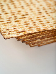 Traditional Jewish treat for Passover. Lots of matzo on a plain white background. Traditions, refreshments, the feast of the Jewish Passover. High angle view. Close-up.