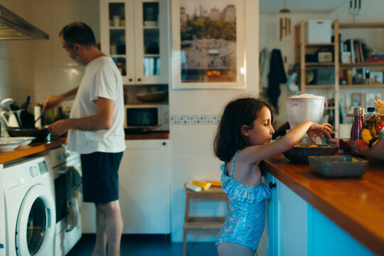 Domestic summer kitchen scene with father and daughter