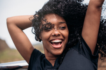 Happy ethnic female with curly hair
