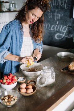 Young Woman Making Strawberry And Lemon Pie 