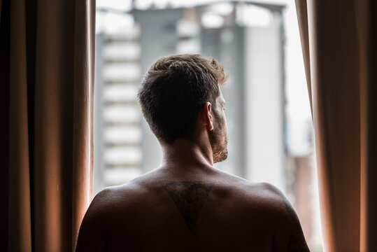 Thoughtful man looking out of window