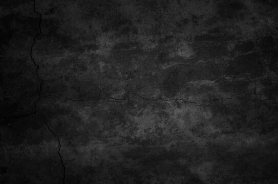 Art black concrete stone texture for background in black. Abstract color dry scratched surface wall grey dark detail covering.