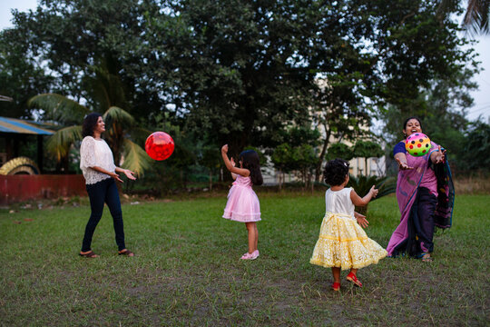 Mother and daughters are playing together at outdoors