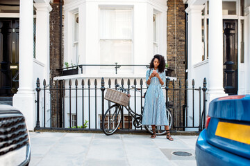 Woman walking on the street using mobile phone