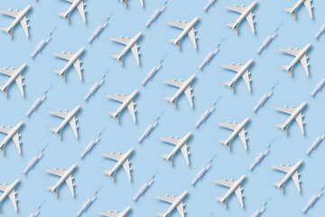 Pattern of white toy planes and syringes