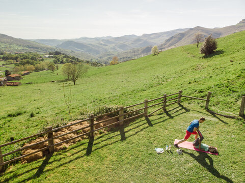 drone view of Multiracial couple training together in mountains